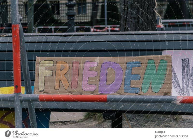 Sign on bench behind barriers, inscription peace Demonstration Peace peace demo Berlin Solidarity Politics and state Humanity Protest War Ukraine Human rights