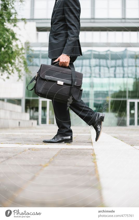 Businessman commuting in the city businessman anonymous unrecognizable street company office building financial district bank urban briefcase going to work