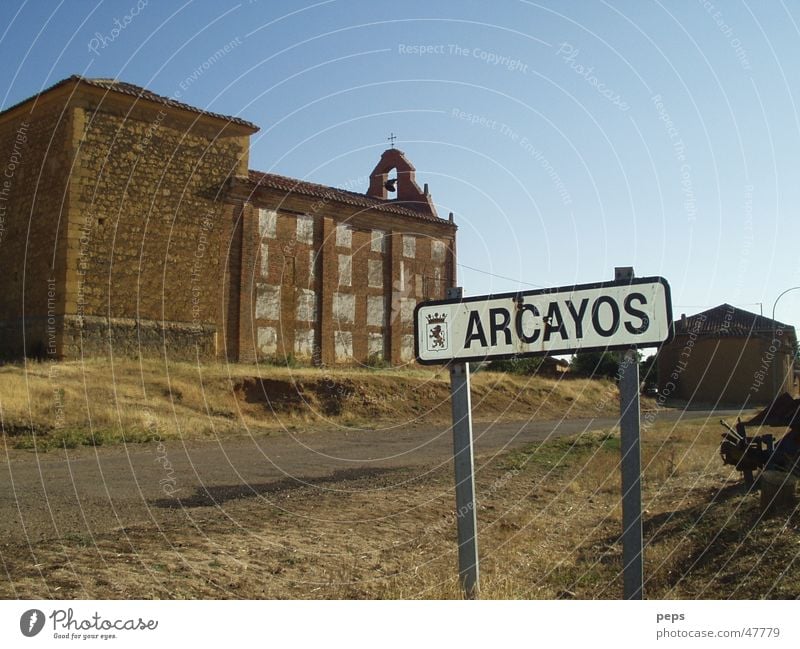 arcayos Spain Arcayos Foreign countries South Cemetery Church yard Street sign Country road Traffic lane Exterior shot Red Brown Beige Physics Summer Gloomy