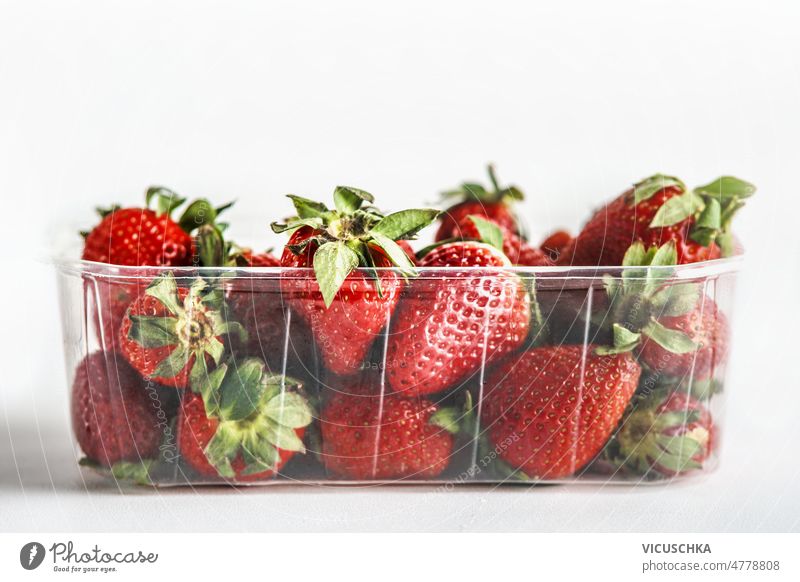 Fresh red strawberries in plastic container at white background fresh healthy delicious seasonal summer front view tasty organic berry food freshness fruit