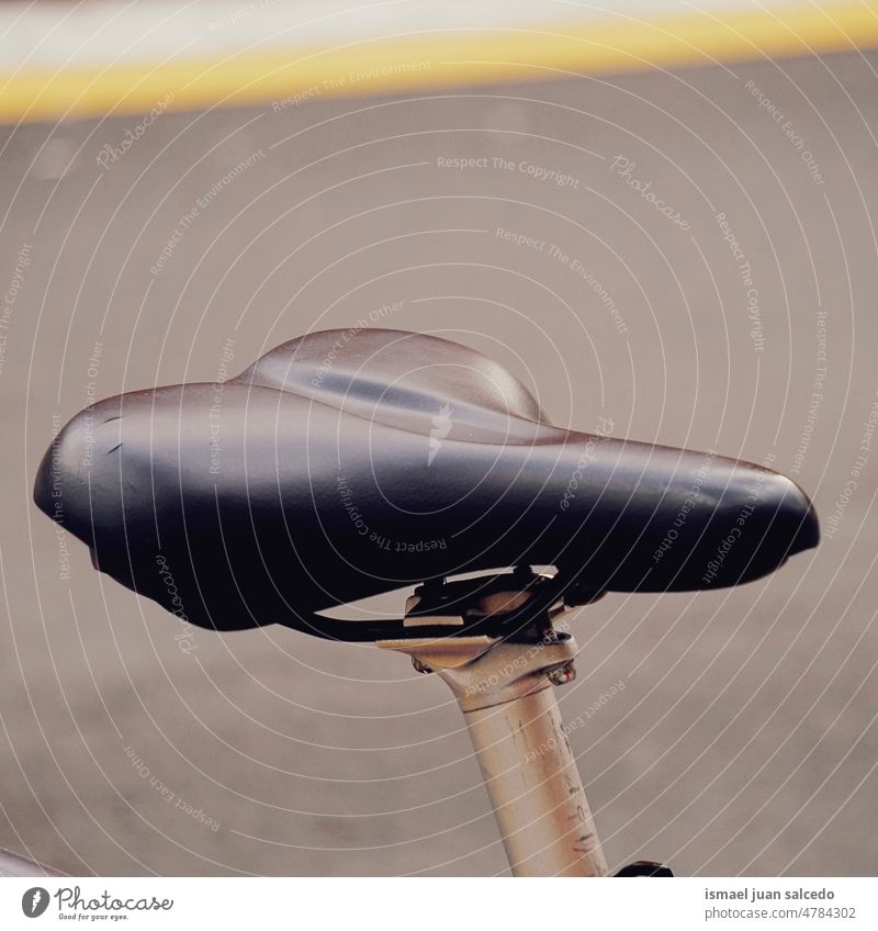 bicycle seat, mode of transportation in the city bike black cycling biking object hobby street outdoors old
