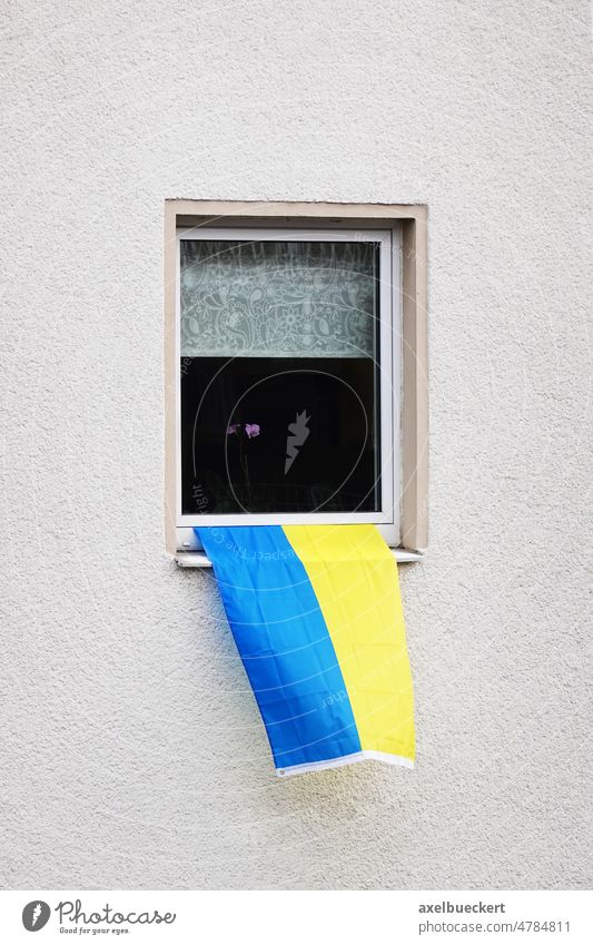 flag of ukraine hanging from window of residential building Flag of Ukraine blue yellow ukrainian solidarity house national color symbol patriotism country