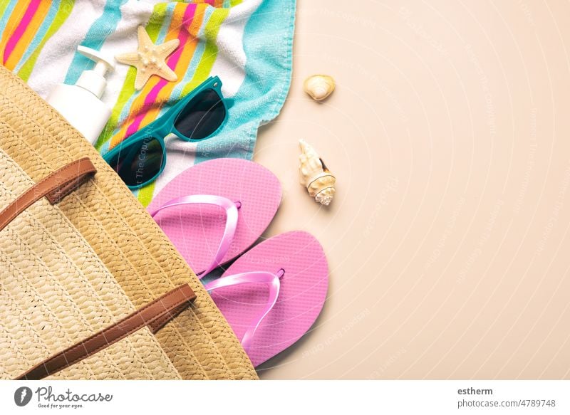 Summer holiday concept.Top view of beach bag with flip flops,beach towel,sunglasses,sea shells and starfish summer holidays summertime vacation travel coast