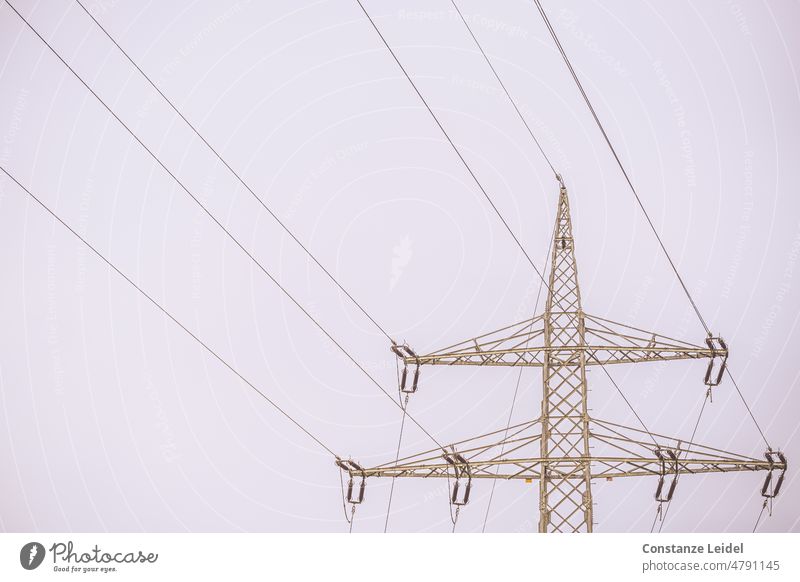 Power pole with six lines against bright sky Electricity pylon transmission line Energy industry high voltage stream High voltage power line Technology