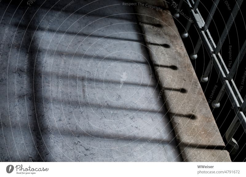 Shadow of a staircase railing on the floor, silent and semi-darkness Pattern low-contrast lines Metal Linoleum Stairs Banister chill quiet dim