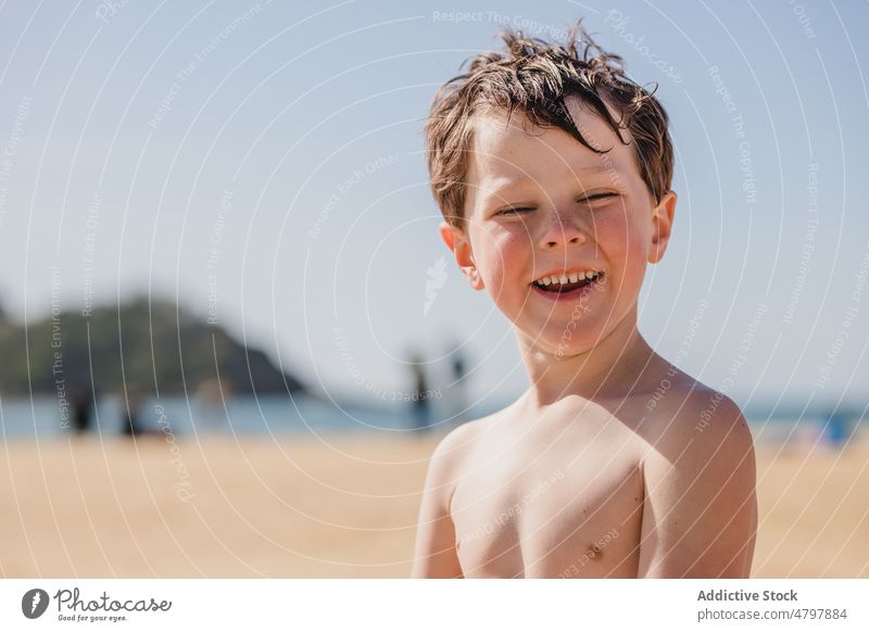 Little boy sitting on sandy beach - a Royalty Free Stock Photo from ...