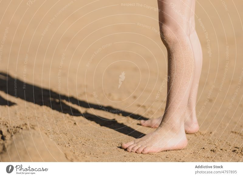 Unrecognizable kid on sandy beach summer coast childhood rest shore pastime leg leisure seashore seacoast resort coastal recreation summertime environment