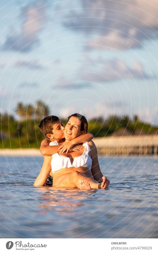Son hugging his mother on the beach beautiful boy child coast cute family finger fun happiness happy holiday infant island joy kid leisure lifestyle love