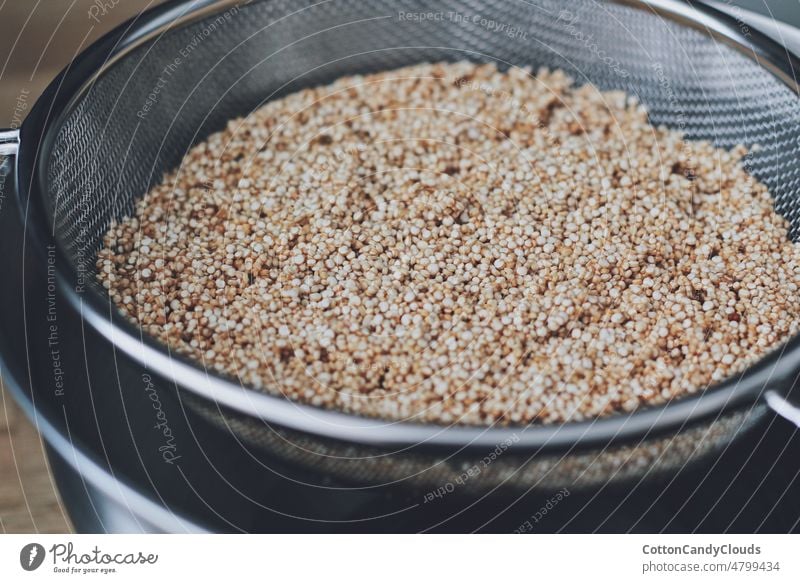Quinoa in a metal strainer vegan closeup uncooked bowl grain isolated brown white sugar healthy seed ingredient raw organic cereal natural vegetarian buckwheat