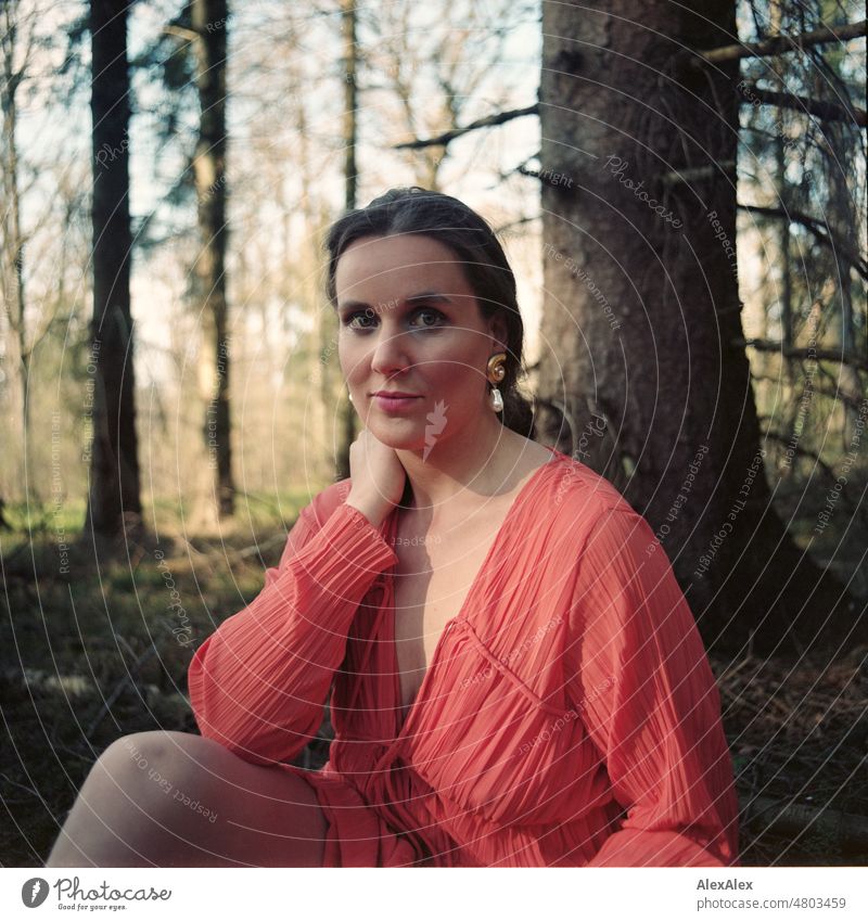 analog medium format portrait of young woman in orange dress sitting in a forest Woman Young woman pretty Feminine feminine Identity Authentic Esthetic Adults