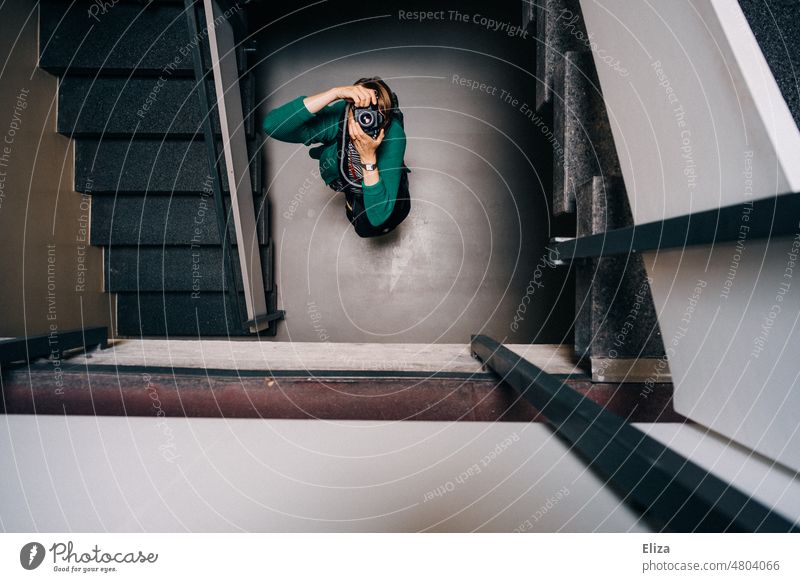 [hansa BER 2022] A woman stands in the stairwell and takes pictures with her camera upwards Take a photo Staircase (Hallway) Woman inside upstairs staircases