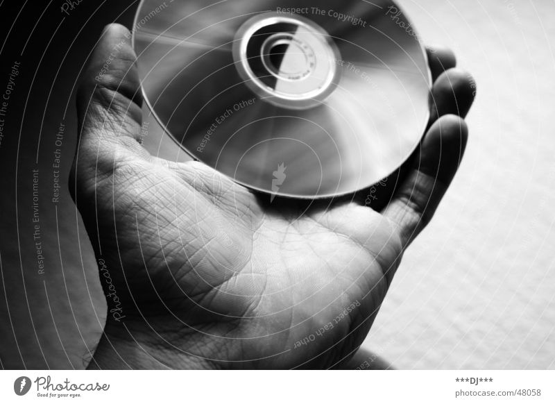 data transfer CD Hand Thumb Fingers Multimedial Media Data storage Reflection compact disc Black & white photo Shadow