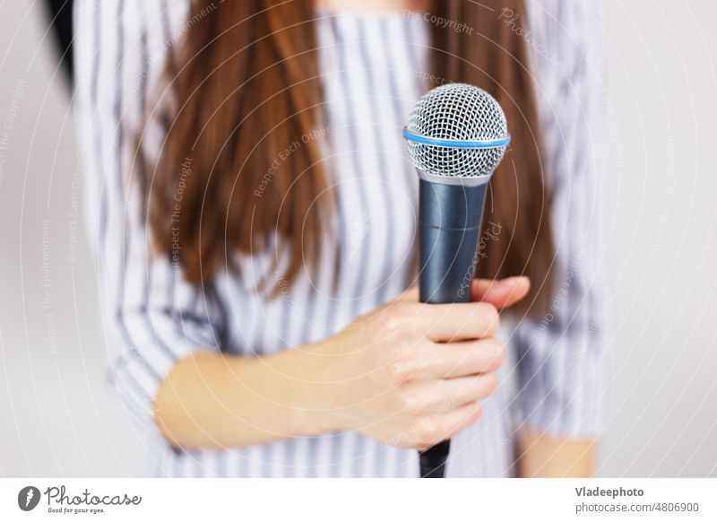 Microphone in women's hand singing or public speaking woman girl microphone young music singer entertainment sound studio person concert musician people