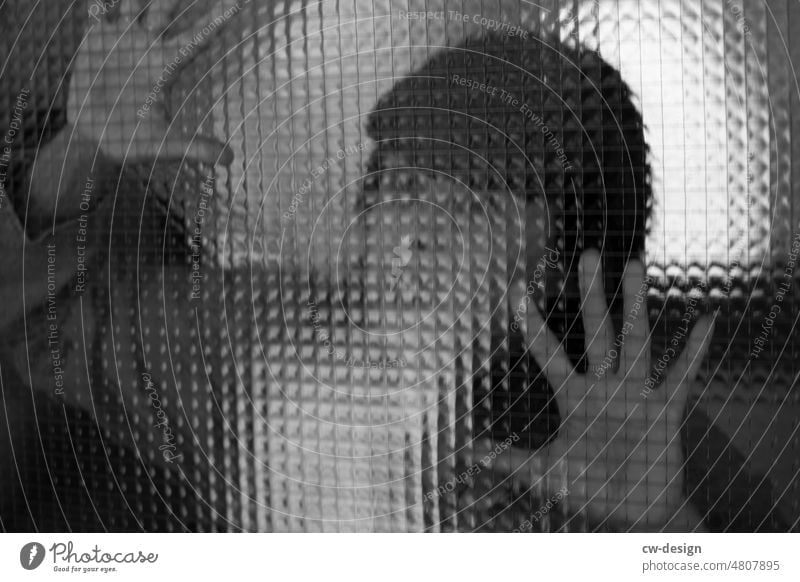 Woman behind a pane of glass Glass Pattern hands Light