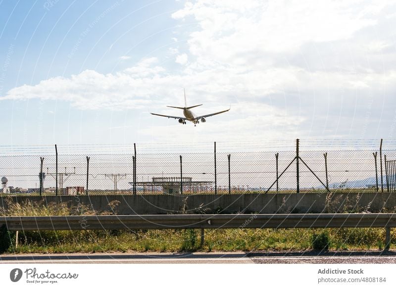 Airplane flying over runway in countryside airport airplane aviation aircraft transport flight landing airfield travel departure vehicle modern trip speed