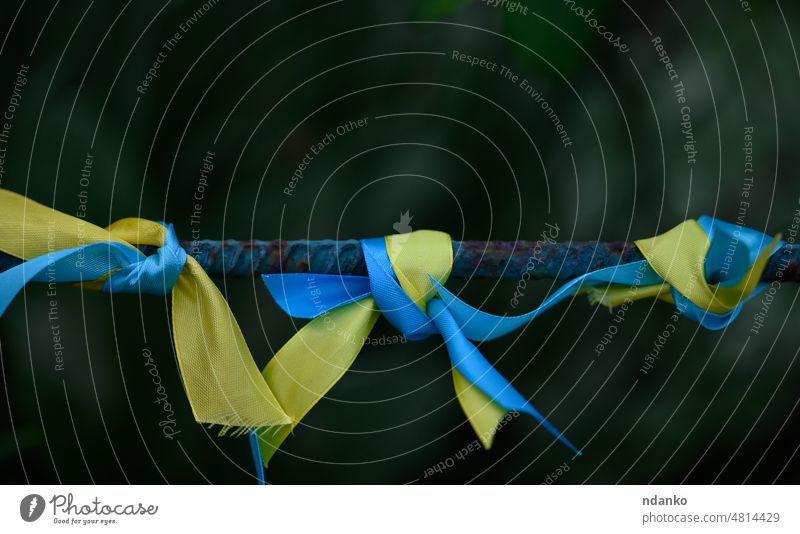 blue and yellow silk ribbon tied on a metal tube. Ukrainian flag symbol, struggle for independence ukraine ukrainian freedom national patriot patriotism country