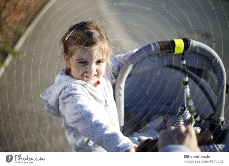 Child in baby carriage Infancy Joie de vivre (Vitality) Happy Authentic Playing naturally Human being Leisure and hobbies active Childhood memory Emotions