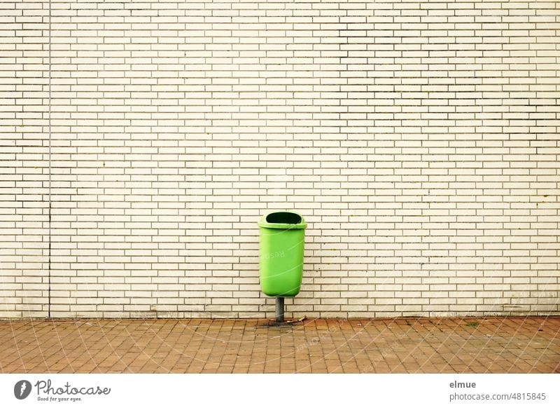 green waste container for residual waste in front of a building in beige clinker cladding / garbage disposal waste bins Outdoor waste collector Clinker cladding