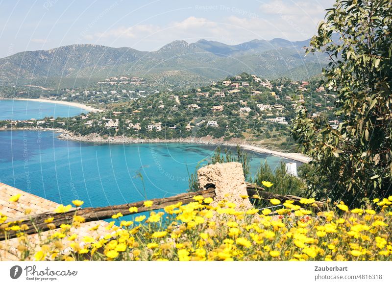 View of a bay in Sardinia, mountains, fence, white villas, yellow flowers Bay Villas Ocean Mediterranean sea Hill Island Blue Yellow bank coast Water