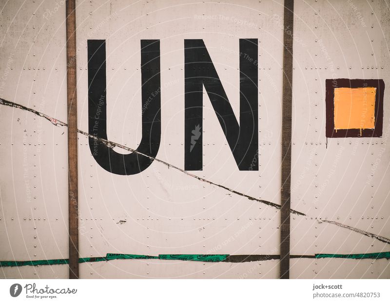 Abbreviation for the United Nations on a metal wall un Container Metal Typography Characters Capital letter Detail Politics and state Symbols and metaphors
