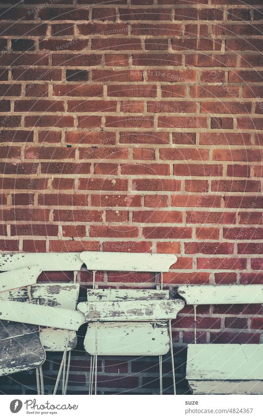 With the A**** on the wall Wall (building) Brick wall Facade Wall (barrier) Deserted Old Gloomy Chair Seating seating group Furniture Backrest Colour photo