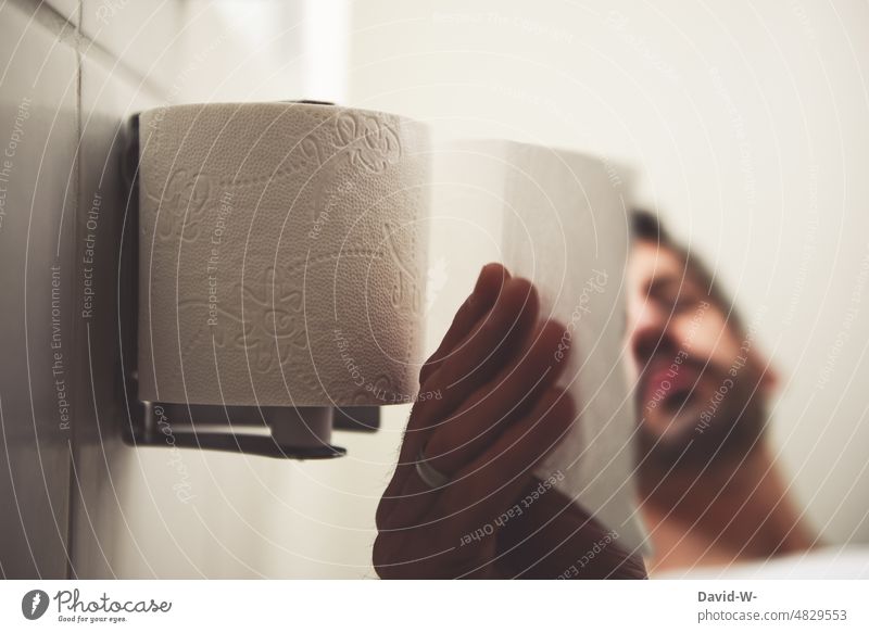 Man grabs the toilet paper on the toilet Toilet paper Grasp john Sit Sanitary LAVATORY Hand
