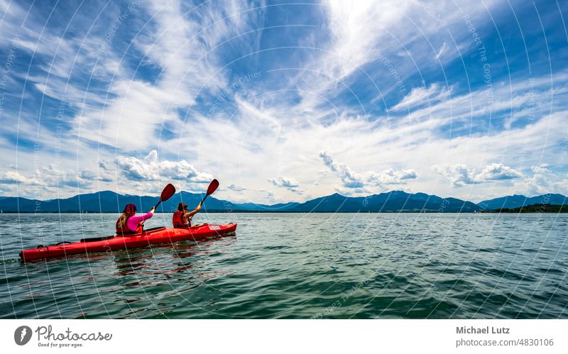 Paddling on the Chiemsee Lake Chiemsee Bavaria Germany Water Alps mountains Kayak Canoe Aquatics activity Activity holiday vacation Nature Sports Adventure