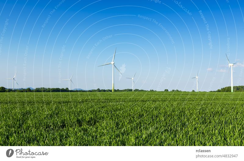 wind wheels in a field wind-turbine wind farm against blue sky agriculture alternative alternative energy biostrom cheap electricity climate change