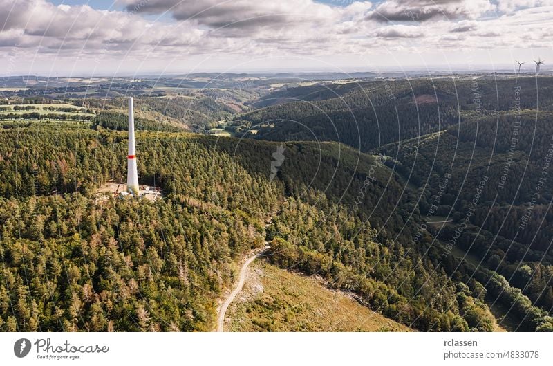 Aerial view of wind turbines uconstruction site forest trees industry wind farm drone generator under construction construction side aerial cloud