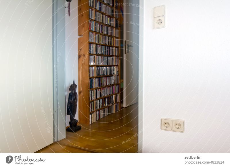 Hallway with wooden figure and CD shelf Passage Room Shelves door dwell Flat (apartment) room Access at home Entrance Way out Wall (building) Wall (barrier)