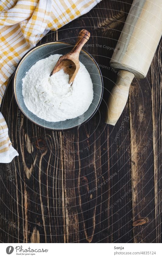 Top view of a bowl of flour and a rolling pin. Rustic wooden table. Flour Rolling pin Table Baked goods Baking Preparation bake bread Wood White Ingredients