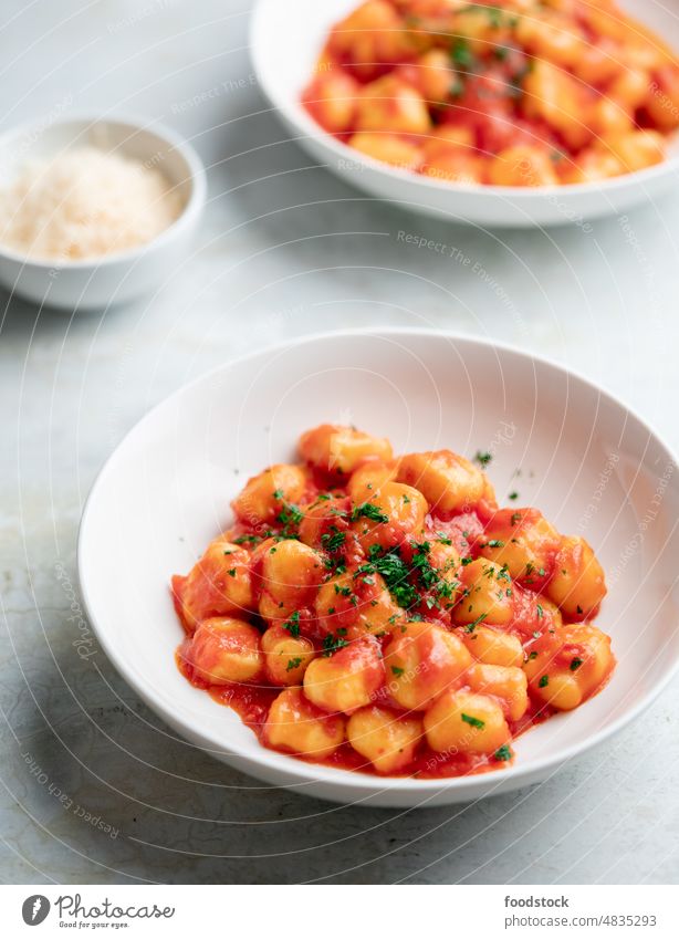 Gnocchi with tomato sauce and parmigiano on a plate. Classic Italy Tomato Sauce basil bowl cheese cooked cuisine culinary delicious diet dinner dish eat flavor