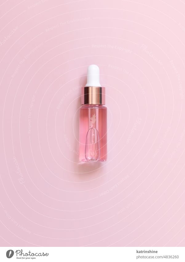 Pink Dropper Bottle on light pink top view. Skincare beauty product bottle mockup white serum pipette glass pastel negative space copy space nobody Brand