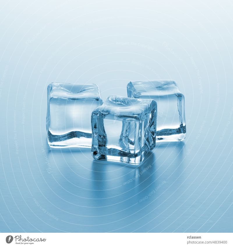 Three clear ice cubes frozen freeze cold cool dice transparent drink frost purity iced cocktail liquid Crystal clear