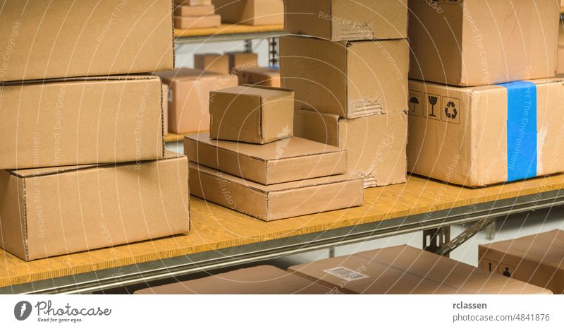 different cardboard boxes on shelves in a warehouse, Packed courier delivery concept image package shipping distribution industry parcel carton factory business