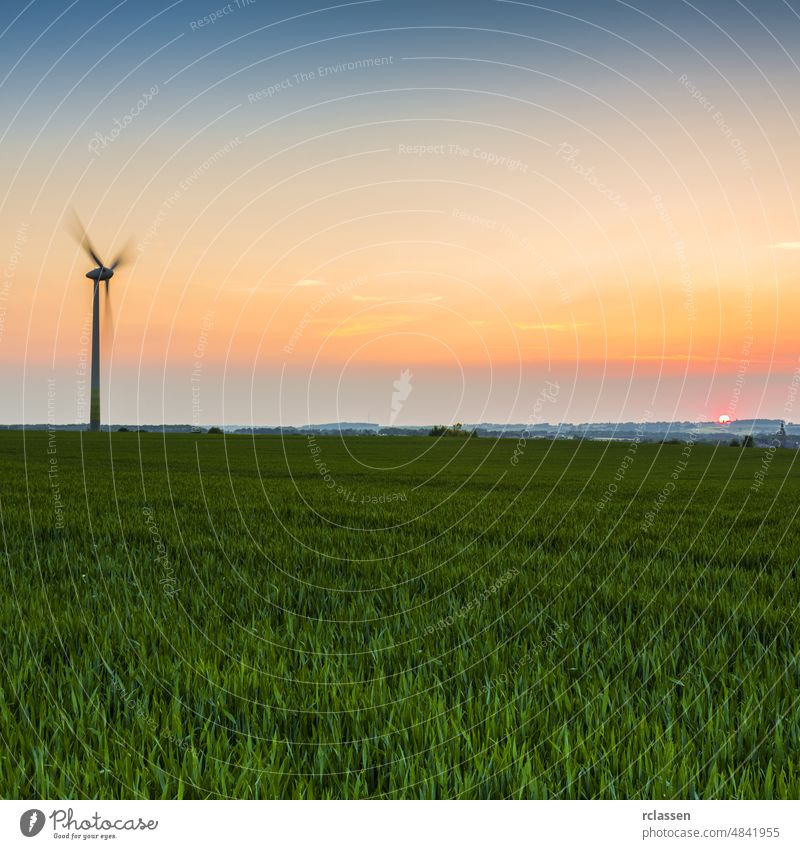 pinwheel in a field against a sunset in the evening twilight alternative alternative energy biostrom blue cheap electricity climate change climate protection