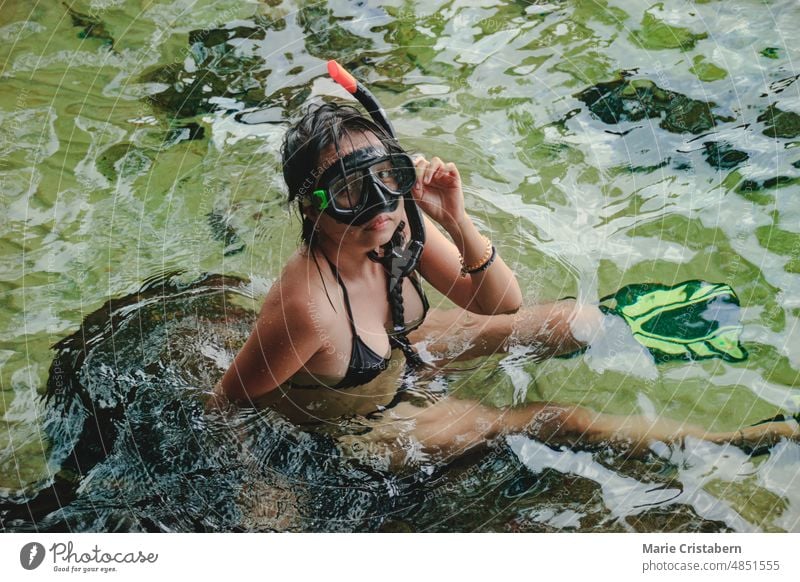 Young asian woman in bikini and snorkel gear while enjoying the clear water of the sea in Koh Sdach Island Cambodia, outdoor summer activity young mask