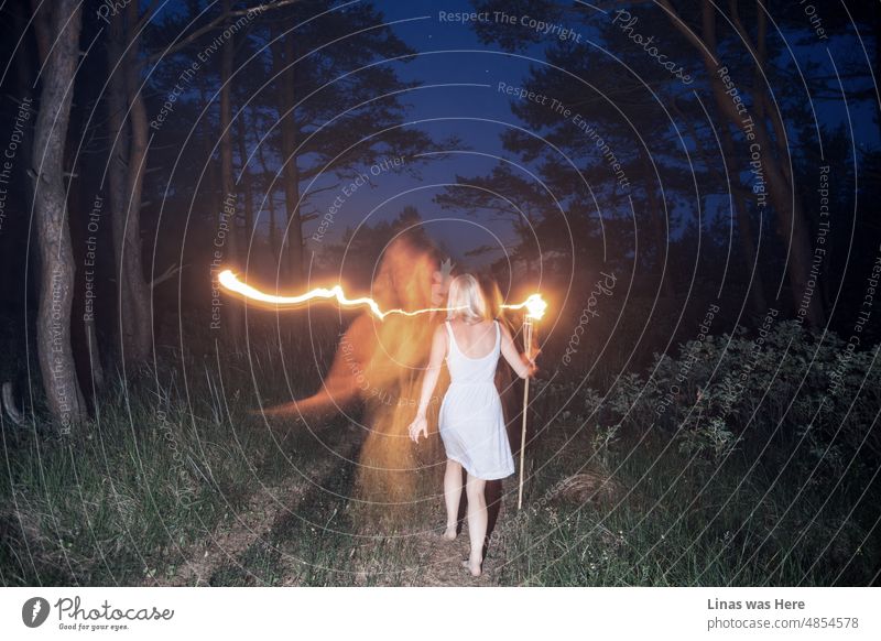 Short midsummer nights have everything. Blonde girls dressed in white, fire caught like a painting, wild nature, and a starry sky. This one also looks ghostly due to long exposure.