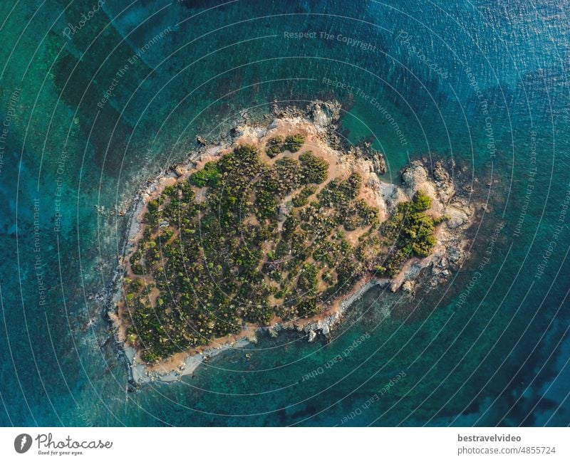 Day drone view above small island with green vegetation and rocky coastline in the Mediterranean at Chalkidiki peninsula, Greece Mediterranean landscape drone