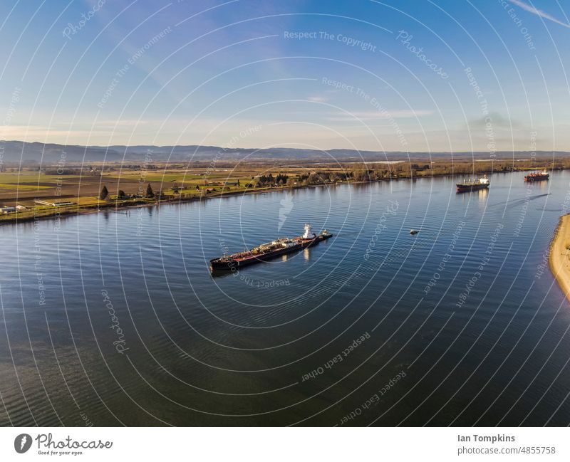 Ships at anchor in a river Blue Shipping boats canal cargo cargo ship columbia river cranes lake ship bow shipping freighter sky water