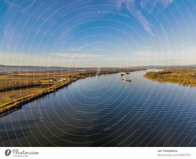 Ships floating in a river Blue Shipping boats canal cargo cargo ship columbia river cranes lake ship bow shipping freighter sky water