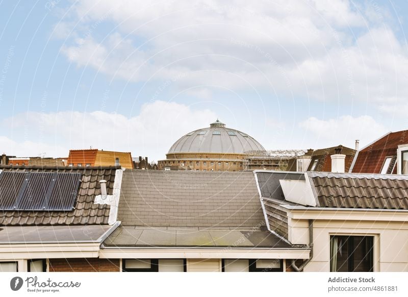 Roofs of typical residential buildings in city district roof architecture facade neighborhood dome exterior tile mansard construction property house housing