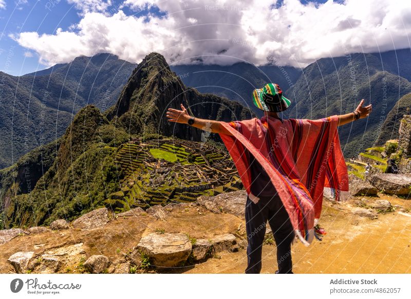Anonymous tourist with outstretched arms enjoying mountains in Peru person valley travel admire traveler explore highland nature viewpoint wanderlust landscape