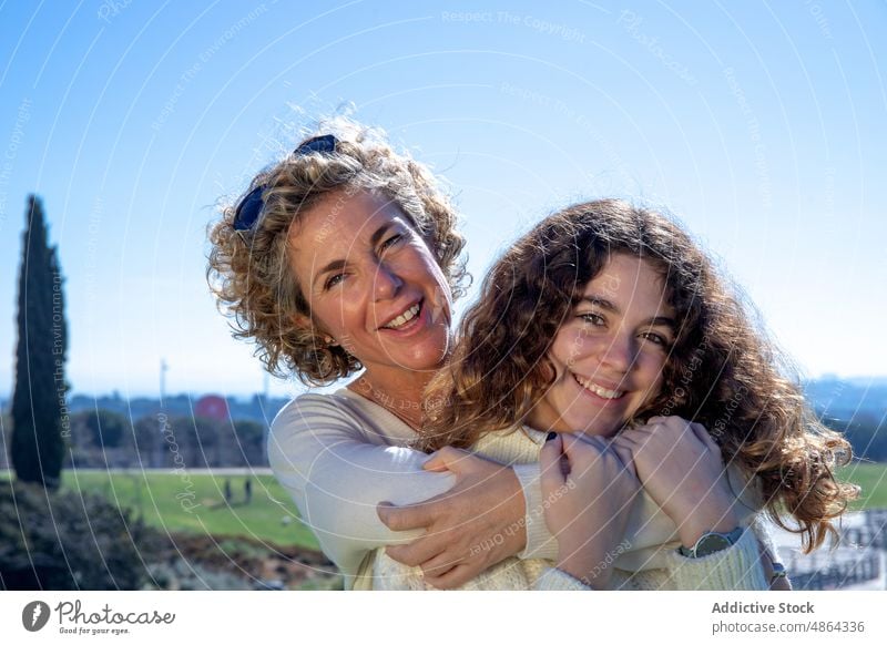 Smiling Mother Embracing Daughter On Sunny Day Sky Love Happy Bonding Family Together Enjoyment Lifestyle Leisure Sunlight Relax Trust Weekend Girl Summer
