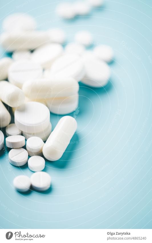 White pills on blue background. medicine pharmacy medication concept care drug supplement tablet health white medical painkiller aspirin antibiotic medicament
