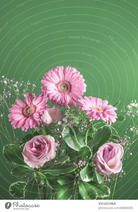 Beautiful flowers bouquet with pink gerbera flowers at green background. beautiful romantic bunch front view copy space birthday bloom blossom colorful floral