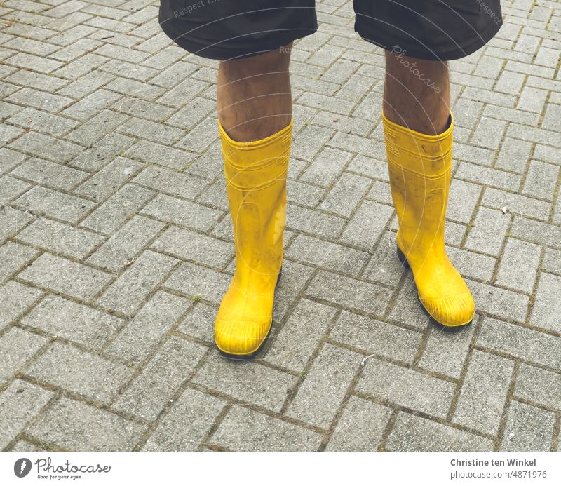 Man legs in yellow rubber boots. The rain can come... Rubber boots Male Legs Legs in rubber boots Yellow Paving stone Boots Footwear Human being short pants