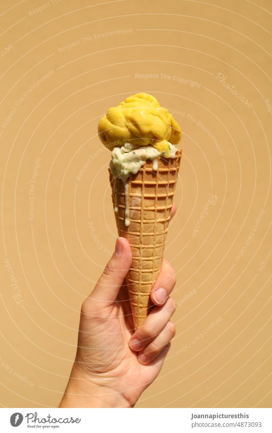 Yellow waffle ice cream in hand in front of yellow wall Ice Fruit ice cream Ice cream Summer cute Dessert Food Refreshment Delicious