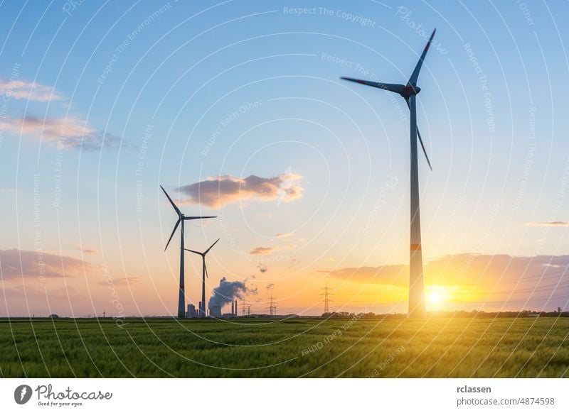 wind farm with coal power plant at sunset steam dusk energy Power Generationenergy supply renewable field electricity pylon sky fired Power Station cornfield