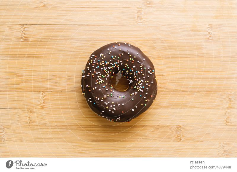 donut with chocolate glazed and sprinkles. directly above shot doughnut baked bakery pink dessert food sugar assorted background breakfast cake colorful